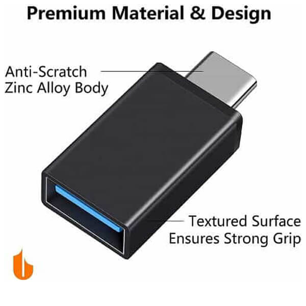 A USB Type-C to OTG Adapter from Generic, designed with a high-quality, anti-scratch zinc alloy body and a textured surface for enhanced grip. The text "Premium Material & Design" showcases its features, including high-speed data transfer capabilities as a USB 3.1 Male to USB 3.0 Female Converter for MacBook Pro, Air & iPad Pro (Black) - Store.