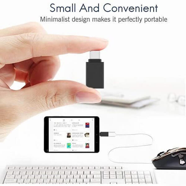 A hand holding a Generic USB Type-C to OTG Adapter - USB 3.1 Male to USB 3.0 Female Converter for MacBook Pro, Air & iPad Pro (Black) above a keyboard, with the adapter connected by a cable to a tablet displaying a music playlist. Text above highlights the high-speed data transfer capabilities of this compact and versatile adapter.