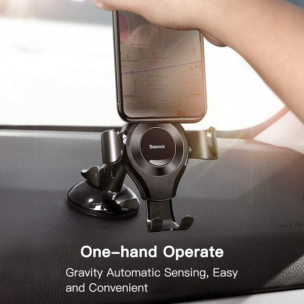 A hand places a smartphone into the BASEUS Gravity Universal Car Phone Holder with Adhesive Mount for dashboard or windshield, highlighting one-hand operation, hands-free navigation, and automatic gravity sensing.