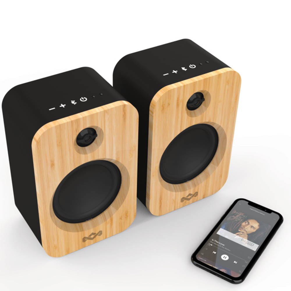 Two MARLEY House of Marley Get Together Duo Bluetooth Wireless Speakers with black sides sit beside a smartphone showing a music player on a white surface, offering premium sound quality.