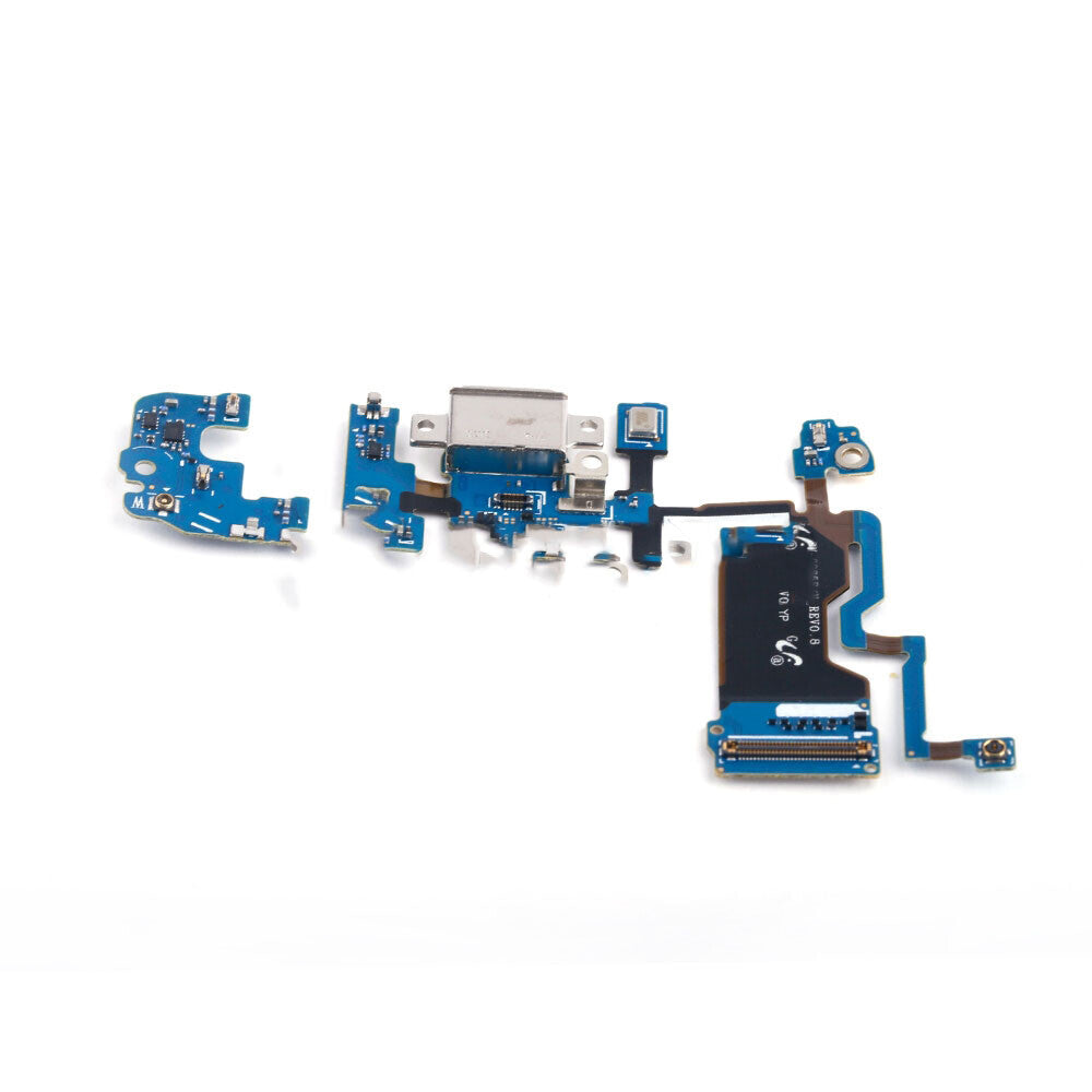 A disassembled Samsung Galaxy S9 Plus circuit board with various blue and black electronic components, including an original OG Charging Port Flex Cable for Samsung Galaxy S9 Plus, arranged on a white background.