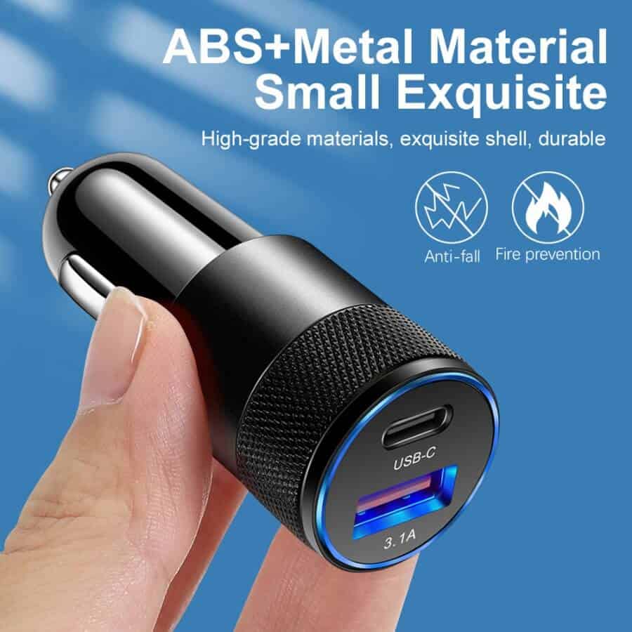 A close-up shot of a person's hand holding a black SMART KOALA 38W Dual Port PD & 3.1A USB Fast Car Charger Socket Adapter. Text overlays describe the device as made of ABS+metal material, small, exquisite, anti-fall, and fire-preventive.