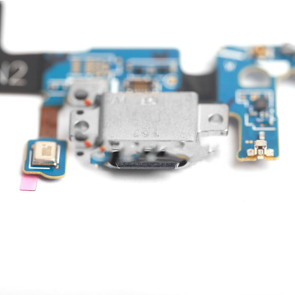 Close-up of a blue and silver electronic circuit board component with various small parts and connectors visible against a white background, designed for OEM quality Samsung Galaxy S9 charging port replacements.