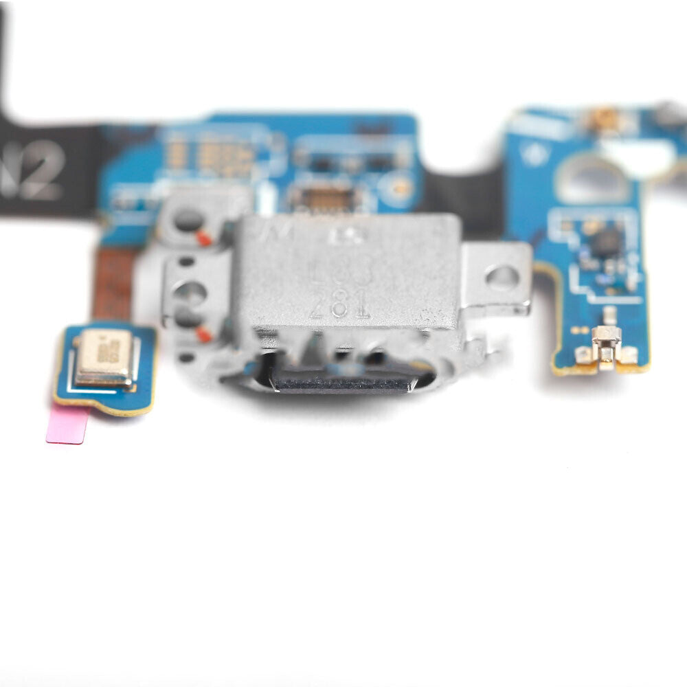 Close-up image of an OG Charging Port Flex Cable for Samsung Galaxy S9 (G960U) electronic circuit board, featuring a small connector and various components with visible wiring paths, set against a white background.