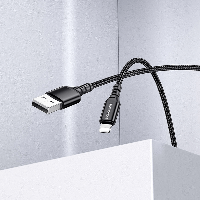 A Borofone BX54 1M Fast Charging Lightning Data Sync Cable, a high-quality accessory by BOROFONE for mobile and laptop repair, with a sleek braided design in black, is draped over a white surface, promising fast charging.