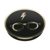 Round black and gold PopSockets PopGrip Licensed - Harry Potter emblem with a lightning bolt and glasses icon, featuring swappable PopTops for wireless charging.
