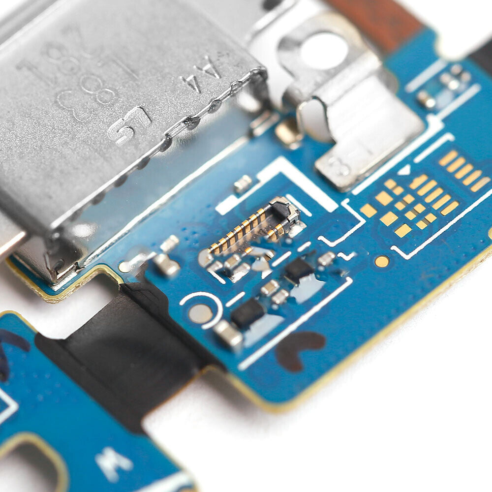 Close-up view of a blue printed circuit board with various electronic components, including a metallic connector and microchips, resembling the Charging Port Flex Cable from an OG Samsung Galaxy S9 (G960U).