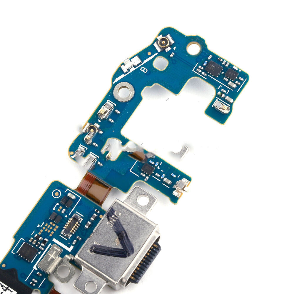 A close-up of a blue and silver circuit board with various electronic components and connectors, showcasing an OG Charging Port Board for the Samsung Galaxy S9 G960F.