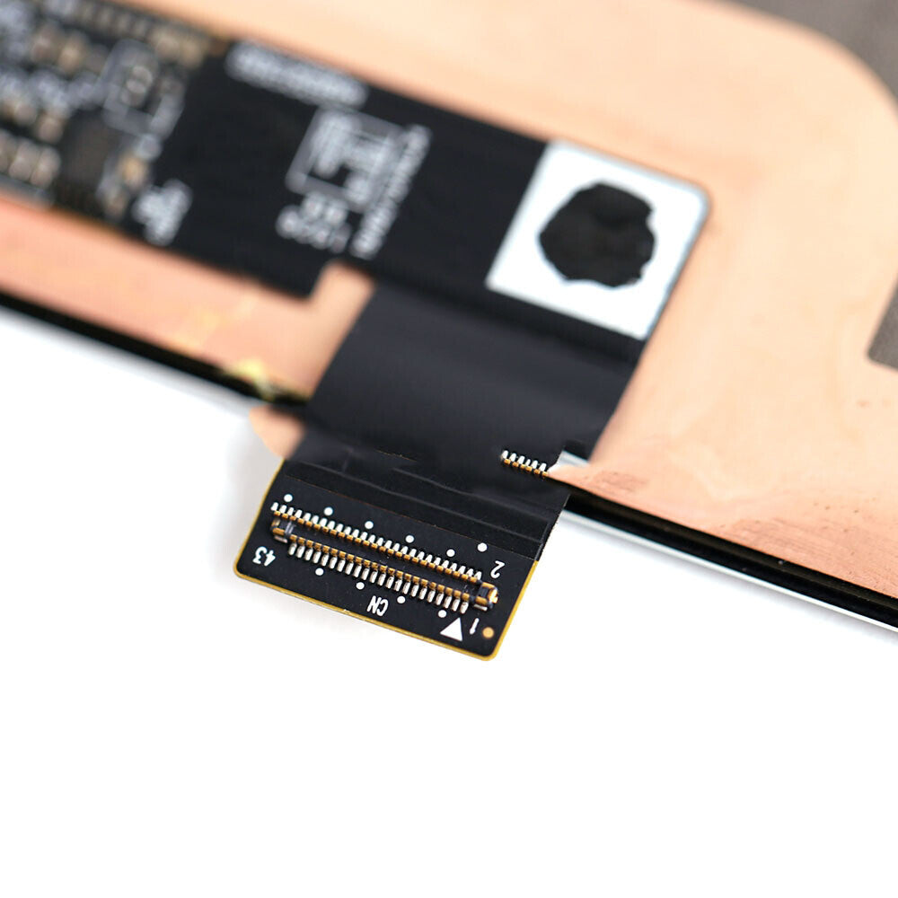 Close-up of an electronic component with a black ribbon cable connected to a circuit board, showing exposed pins and connectors from a refurbished OG Display Assembly for Google Pixel 4 (Black).