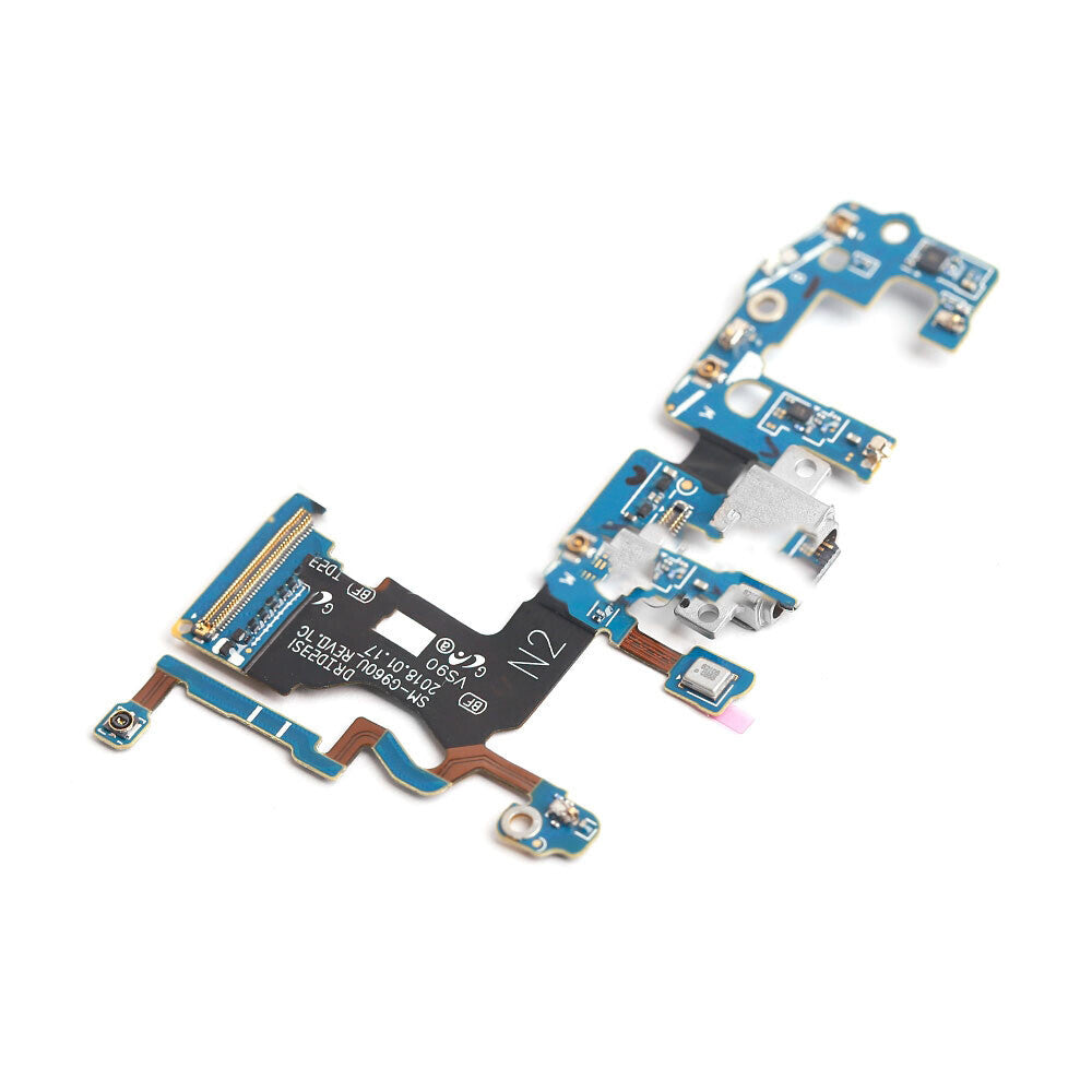 A blue electronic circuit board with various components, including connectors and chips, features an OG Charging Port Flex Cable for Samsung Galaxy S9 (G960U) laid out on a white background.